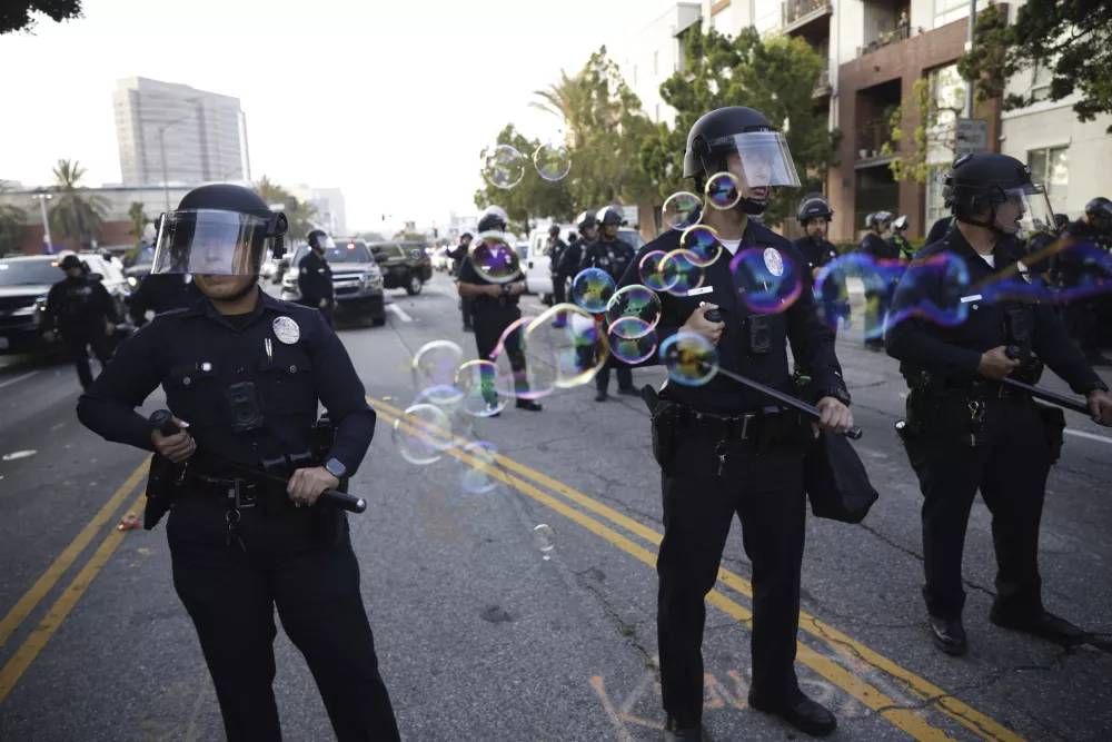 Demonstrators face off with Los Angeles Police Department officers during a protest in response to a series of United States Immigration and Customs Enforcement (ICE) raids, in Los Angeles, Calif., Monday, June 9, 2025. (Stephen Lam/San Francisco Chronicle via AP)