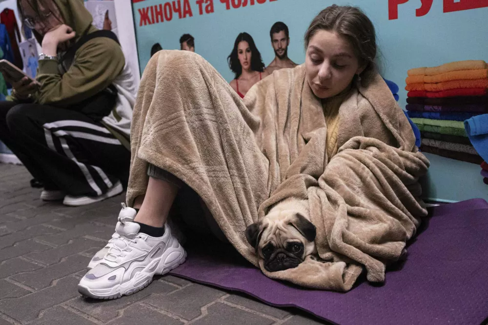 People rest in a metro station, being used as a bomb shelter, during a Russian drones attack in Kyiv, Ukraine, early Tuesday, June 10, 2025. (AP Photo/Zoya Shu)