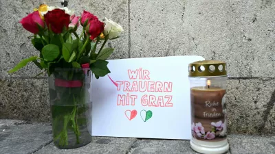 11 June 2025, Austria, Vienna: Candles and flowers are placed in front of St. Stephen's Cathedral in central Vienna, where a poster reads "We mourn with Graz," after a school rampage in Graz left eleven people dead. Photo: Helmut Fohringer/APA/dpa