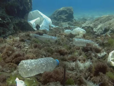 Massive plastic pollution of the ocean bottom. Seabed covered with a lot of plastic garbage. Bottles, bags and other plastic debris on seabed in Mediterranean Sea. Plastic pollution of the Ocean