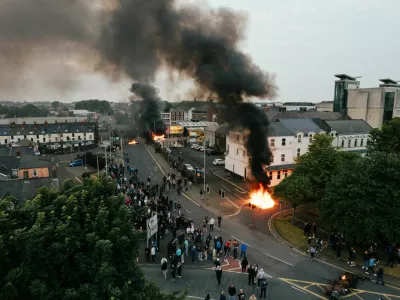 Drone view of smoke and fire rising amid riots in Ballymena, Northern Ireland June 10, 2025 in this picture obtained from social media. @laganphoto via Instagram/via REUTERS THIS IMAGE HAS BEEN SUPPLIED BY A THIRD PARTY. MANDATORY CREDIT.