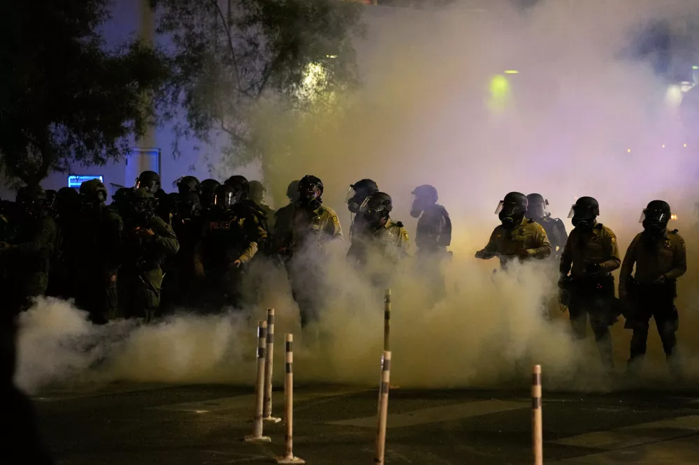 Police fire chemical irritants during protests over President Donald Trump's stepped-up enforcement of immigration laws, Wednesday, June 11, 2025, in Las Vegas. (AP Photo/John Locher)