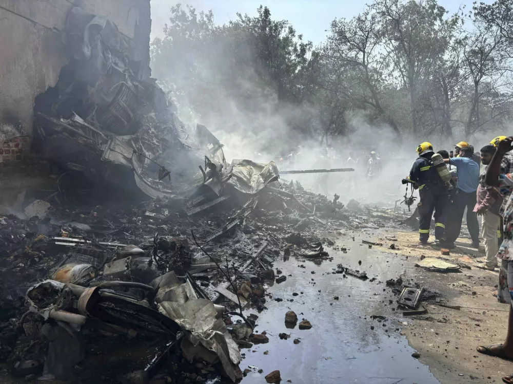 Firefighters work at the site of an airplane that crashed in India's northwestern city of Ahmedabad in Gujarat state, Thursday, June12, 2025. (AP Photo/Ajit Solanki)