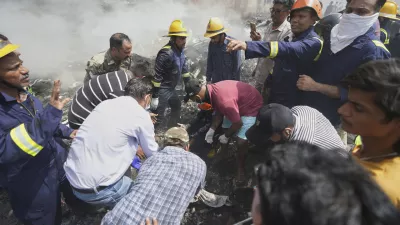 Rescuers work at the site of an airplane that crashed in India's northwestern city of Ahmedabad in Gujarat state, Thursday, June12, 2025. (AP Photo/Ajit Solanki)
