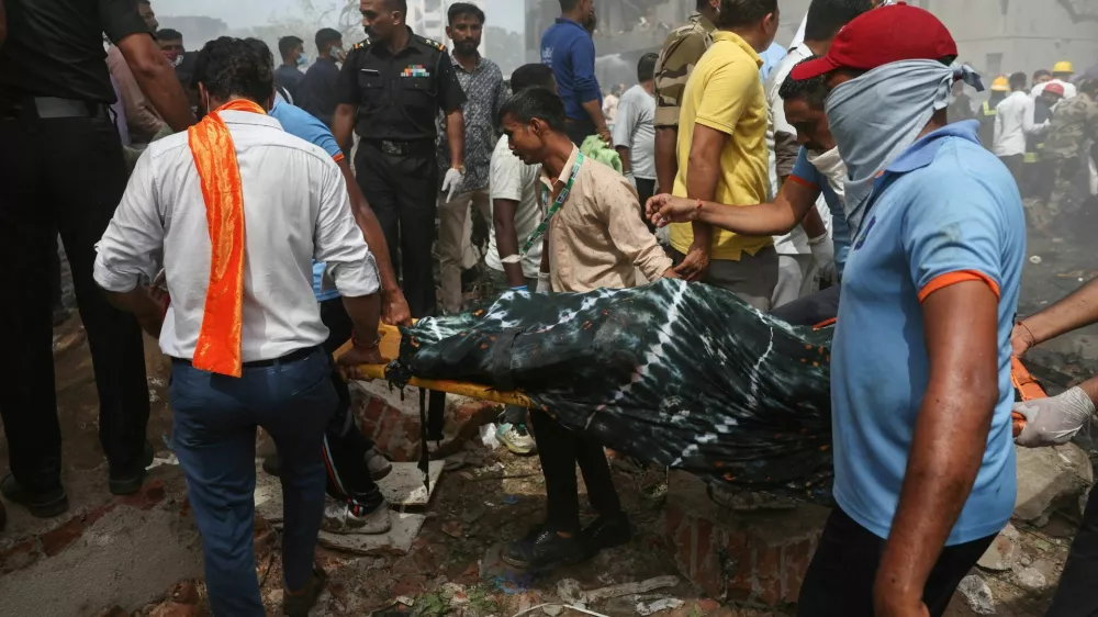 People carry the body of a victim from the crash site after an Air India Boeing 787 Dreamliner plane crashed in Ahmedabad, India, June 12, 2025. REUTERS/Amit Dave   TPX IMAGES OF THE DAY