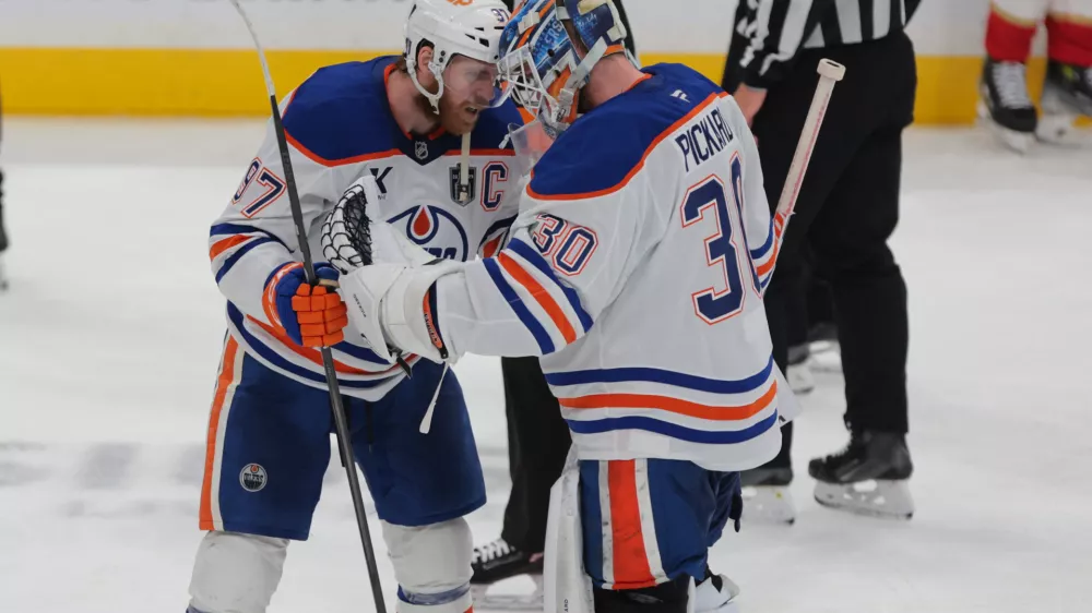 Jun 12, 2025; Sunrise, Florida, USA; Edmonton Oilers center Connor McDavid (97) celebrates with goaltender Calvin Pickard (30) after the win in overtime against the Florida Panthers in game four of the 2025 Stanley Cup Final at Amerant Bank Arena. Mandatory Credit: Sam Navarro-Imagn Images