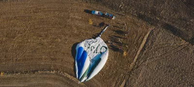 Goreme, Turkey - April 4, 2012: Hot air balloons for tourists flying over rock formations at sunrise in the valley of Cappadocia.