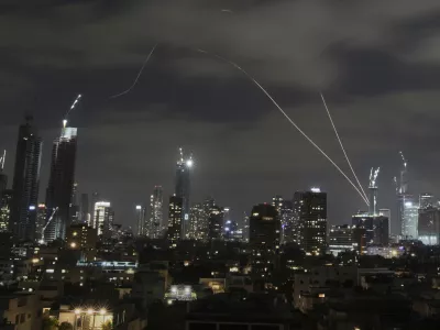 The Israeli Iron Dome air defense system fires to intercept missiles over Tel Aviv, Israel, Sunday, June 15, 2025. (AP Photo/Leo Correa)