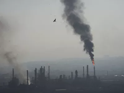 Smoke billows after an Iranian missile struck an oil refinery in Haifa, northern Israel, early Monday, June 16, 2025. (AP Photo/Ariel Schalit)