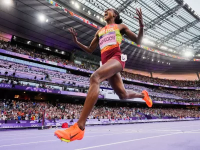 FILE - Faith Kipyegon, of Kenya, celebrates after winning the women's 1500-meter final at the 2024 Summer Olympics, Saturday, Aug. 10, 2024, in Saint-Denis, France.(AP Photo/David J. Phillip, File)