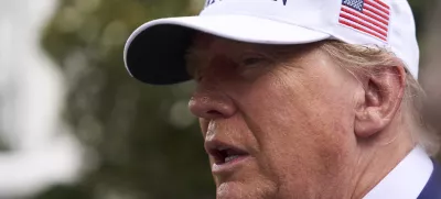 President Donald Trump speaks with reporters as a flag pole is installed on the South Lawn of the White House, Wednesday, June 18, 2025, in Washington. (AP Photo/Evan Vucci)