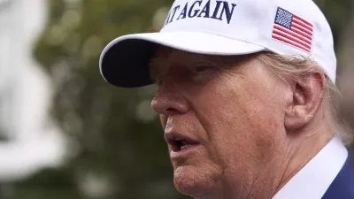 President Donald Trump speaks with reporters as a flag pole is installed on the South Lawn of the White House, Wednesday, June 18, 2025, in Washington. (AP Photo/Evan Vucci)