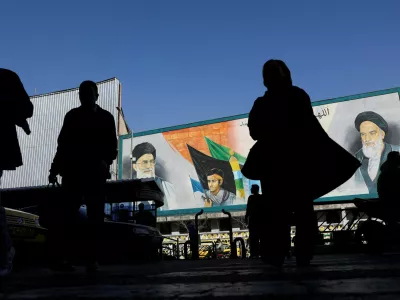 FILE PHOTO: People walk near a mural featuring images of Iran's Supreme Leader Ayatollah Ali Khamenei and leader of Iran's 1979 Islamic Revolution Ayatollah Ruhollah Khomeini, on a street in Tehran, Iran, February 17, 2026. Majid Asgaripour/WANA (West Asia News Agency) via REUTERS ATTENTION EDITORS - THIS PICTURE WAS PROVIDED BY A THIRD PARTY/File Photo