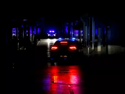 FILE PHOTO: Police car patrols a shopping street without electric lighting to prevent theft and looting in the stores during a power outage which hit large parts of Spain, in Ronda, Spain April 28, 2025. REUTERS/Jon Nazca/File Photo