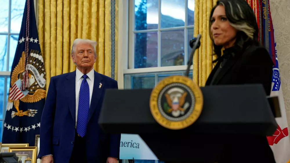 FILE PHOTO: U.S. President Donald Trump looks at Director of National Intelligence Tulsi Gabbard, on the day of Gabbard's swearing in ceremony, in the Oval Office at the White House in Washington, D.C., U.S., February 12, 2025. REUTERS/Nathan Howard/File Photo