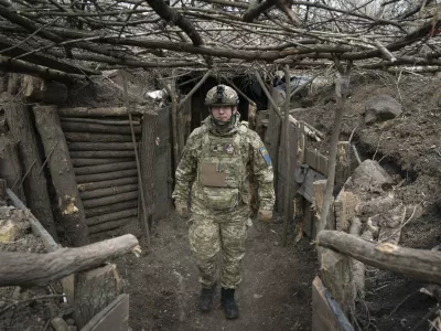 FILE - A Ukrainian serviceman of the 28th Separate Mechanised Brigade stands in a trench at the front line, near Bakhmut, Donetsk region, Ukraine, March 3, 2024. (AP Photo/Efrem Lukatsky, File)