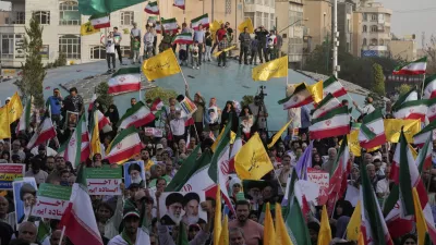 Iranian protesters wave their country's flags and banners containing slogans in support of Supreme Leader Ayatollah Ali Khamenei in an anti-U.S. and anti-Israeli rally at Enqelab-e-Eslami (Islamic Revolution) square in downtown Tehran, Iran, Tuesday, June 24, 2025. (AP Photo/Vahid Salemi)