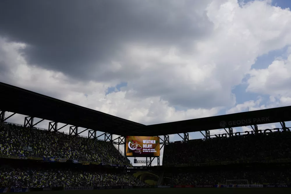 The scoreboard displays a weather delay during the Club World Cup Group C soccer match between Auckland City and Boca Juniors in Nashville, Tenn., Tuesday, June 24, 2025. (AP Photo/George Walker IV)