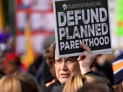 FILE PHOTO: An anti-abortion marcher carries a sign calling for the organisation Planned Parenthood to loose funding, during in the 46th annual March for Life at the Supreme Court in Washington, U.S., January 18, 2019. REUTERS/Joshua Roberts/File Photo