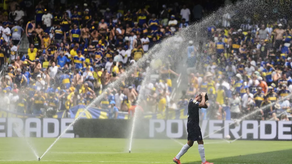 Auckland City's Gerard Garriga cools off under the sprinklers during a water break in the Club World Cup Group C soccer match between Auckland City and Boca Juniors in Nashville, Tenn., Tuesday, June 24, 2025. (AP Photo/George Walker IV)
