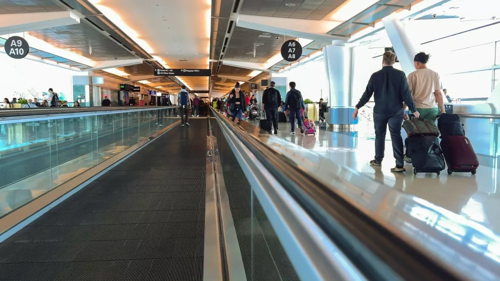 San Francisco, California, USA. August 2, 2024. Passengers walking through a brightly lit terminal at San Francisco International Airport with moving walkways.,Image: 906525354, License: Royalty-free, Restrictions: Contributor country restriction: Worldwide, Worldwide.Contributor usage restriction: Advertising and promotion, Consumer goods.Contributor media restriction: {30654A15-EEB5-421D-826F-3628BBF21768}, {30654A15-EEB5-421D-826F-3628BBF21768}., Model Release: no