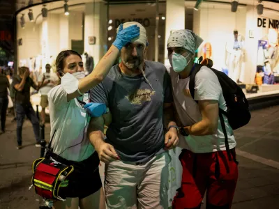 An injured demonstrator is helped during an anti-government protest demanding snap elections, in Belgrade, Serbia, June 28, 2025. REUTERS/Marko Djurica