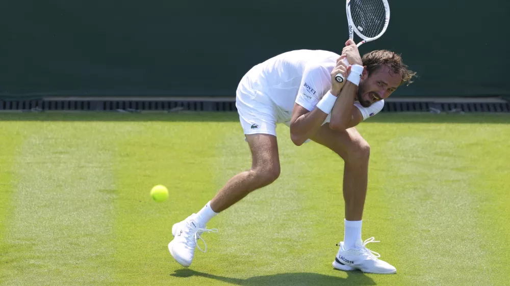 Daniil  Medvedev of Russia returns the ball to Benjamin Bonzi of France during their first round men's single match at the Wimbledon Tennis Championships in London, Monday, June 30, 2025. (AP Photo/Kirsty Wigglesworth)