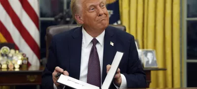 FILE - President Donald Trump signs executive orders in the Oval Office of the White House, Jan. 20, 2025, in Washington. (AP Photo/Evan Vucci, File)