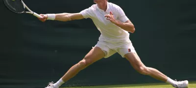 Jannik Sinner of Italy plays a return to Luca Nardi of Italy during their first round men's singles match at the Wimbledon Tennis Championships in London, Tuesday, July 1, 2025.(AP Photo/Kirsty Wigglesworth)