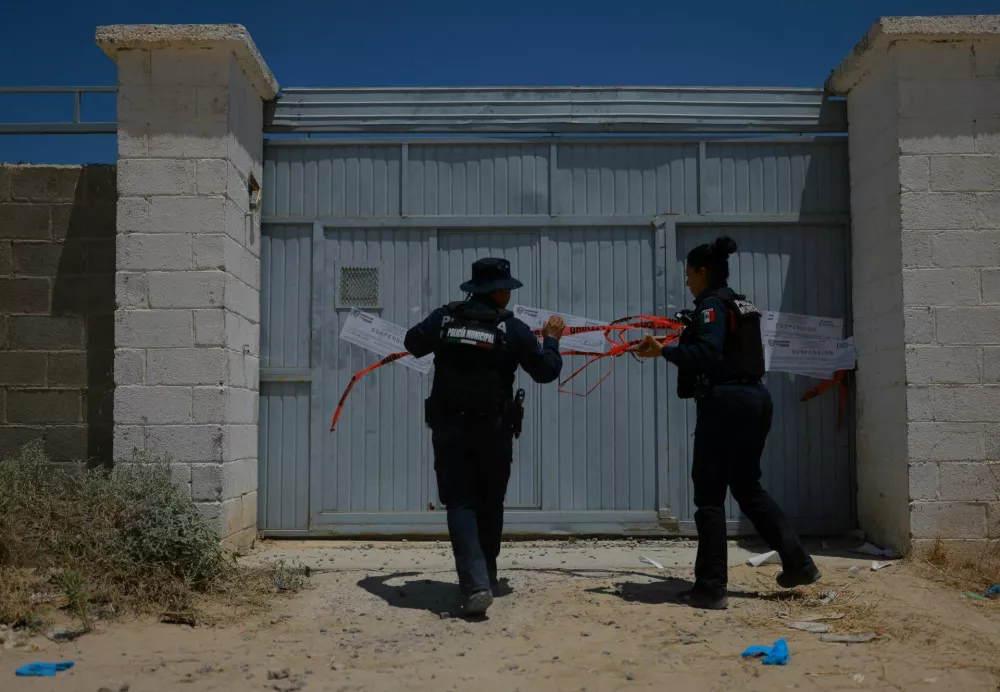 Police officers cordon off a crematorium where authorities found bodies piled up in unsanitary conditions, after local funeral homes hired its services for cremation, according to the Chihuahua State Prosecutor's Office, in Ciudad Juarez, Mexico June 30, 2025. REUTERS/Jose Luis Gonzalez   TPX IMAGES OF THE DAY