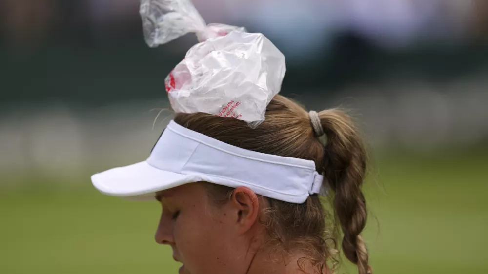 Veronika Erjavec of Slovenia uses an ice bag during her first round women's singles match against Marta Kostyuk of Ukraine at the Wimbledon Tennis Championships in London, Tuesday, July 1, 2025.(AP Photo/Kirsty Wigglesworth)