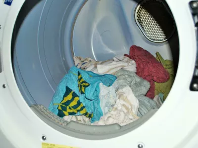 2DENKTA Load of wet towels going into the dryer on laundry day