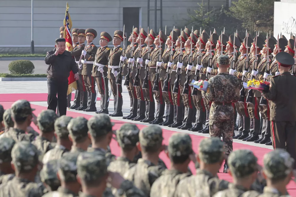 In this photo provided by the North Korean government, North Korean leader Kim Jong Un, left on red carpet, visits the headquarters of the North Korean People's Army's 2nd Corps at an undisclosed place in North Korea Thursday, Oct. 17, 2024. Independent journalists were not given access to cover the event depicted in this image distributed by the North Korean government. The content of this image is as provided and cannot be independently verified. (Korean Central News Agency/Korea News Service via AP)