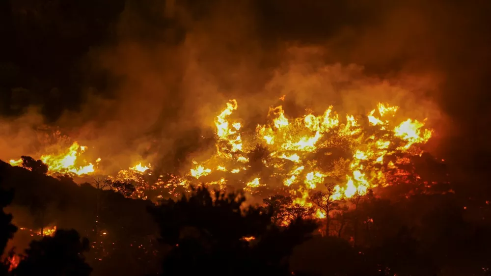 Flames rise as a wildfire burns near Ierapetra, on the island of Crete, Greece, July 2, 2025. REUTERS/Stefanos Rapanis