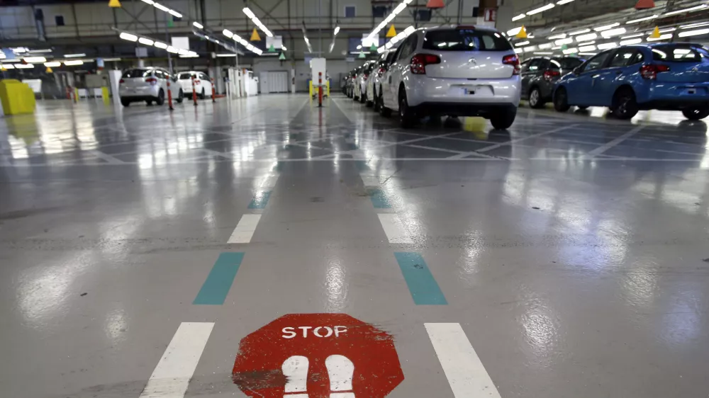 FILE - This Jan.28 2013 file photo, shoiws the French car manufacturer PSA Peugeot Citroen assembly line in Aulnay-sous-Bois, north of Paris. The maker of Peugeot and Citroen cars hopes to lay off 1,300 people this year and hire another 1,300 under new labor rules championed by President Emmanuel Macron to give companies more flexibility to hire and fire. PSA is among the first big companies to apply the new rules, which came into effect this month(AP Photo/Christophe Ena, File)