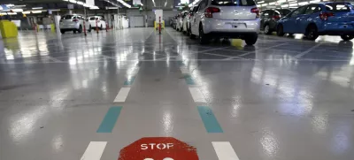 FILE - This Jan.28 2013 file photo, shoiws the French car manufacturer PSA Peugeot Citroen assembly line in Aulnay-sous-Bois, north of Paris. The maker of Peugeot and Citroen cars hopes to lay off 1,300 people this year and hire another 1,300 under new labor rules championed by President Emmanuel Macron to give companies more flexibility to hire and fire. PSA is among the first big companies to apply the new rules, which came into effect this month(AP Photo/Christophe Ena, File)
