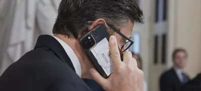 Speaker of the House Mike Johnson, R-La., talks on his phone as he works to push President Donald Trump's signature bill of tax breaks and spending cuts across the finish line at the Capitol in Washington, Wednesday, July 2, 2025. (AP Photo/J. Scott Applewhite)