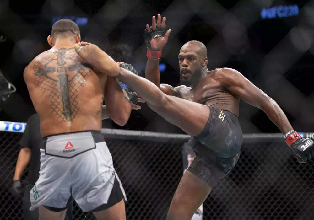 File - In this July 6, 2019, file photo, Jon Jones, right, lands a kick on Thiago Santos during their light heavyweight mixed martial arts title bout at UFC 239 in Las Vegas. UFC light heavyweight champion Jon Jones is denying allegations that he assaulted a waitress in a New Mexico strip club. Denise White, a representative for Jones, said in a statement Monday, July 22, 2019, that he is confident he will be cleared of the "baseless claim." (AP Photo/Eric Jamison, File)