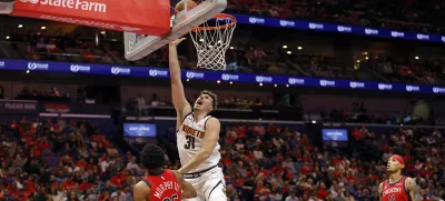 Denver Nuggets forward Vlatko Cancar (31) attempts a layup in front of New Orleans Pelicans guard Trey Murphy III (25) in the second half of an Emirates NBA Cup basketball game in New Orleans, Friday, Nov. 15, 2024. (AP Photo/Tyler Kaufman)