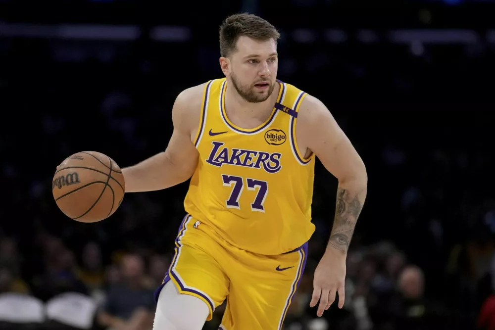 Los Angeles Lakers guard Luka Doncic (77) dribbles up the court during the first half of Game 2 of an NBA first-round playoff series against the Minnesota Timberwolves in Los Angeles, Tuesday, April 22, 2025. (AP Photo/Eric Thayer)