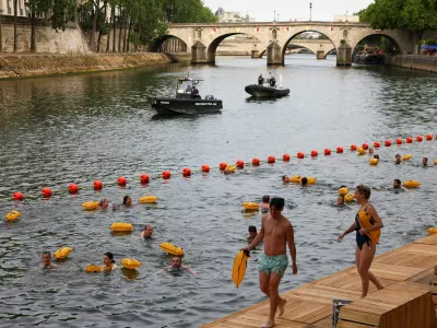 People swim in the River Seine at the Bras Marie site, opened to swimmers marking the first public bathing session in the capital's historic waterway, in Paris, France, July 5, 2025. REUTERS/Abdul Saboor