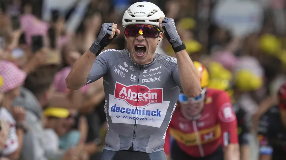 Belgium's Jasper Philipsen celebrates as he crosses the finish line to win the first stage of the Tour de France cycling race over 184.9 kilometers (114.9 miles) with start and finish in Lille, France, Saturday, July 5, 2025. (AP Photo/Thibault Camus)