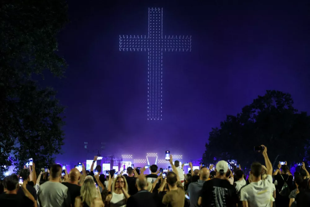 People watch a drone light show, during the concert of Marko Perkovic Thompson, that is poised to break the world record for largest paid concert, in Zagreb, Croatia, July 5, 2025. REUTERS/Antonio Bronic   TPX IMAGES OF THE DAY