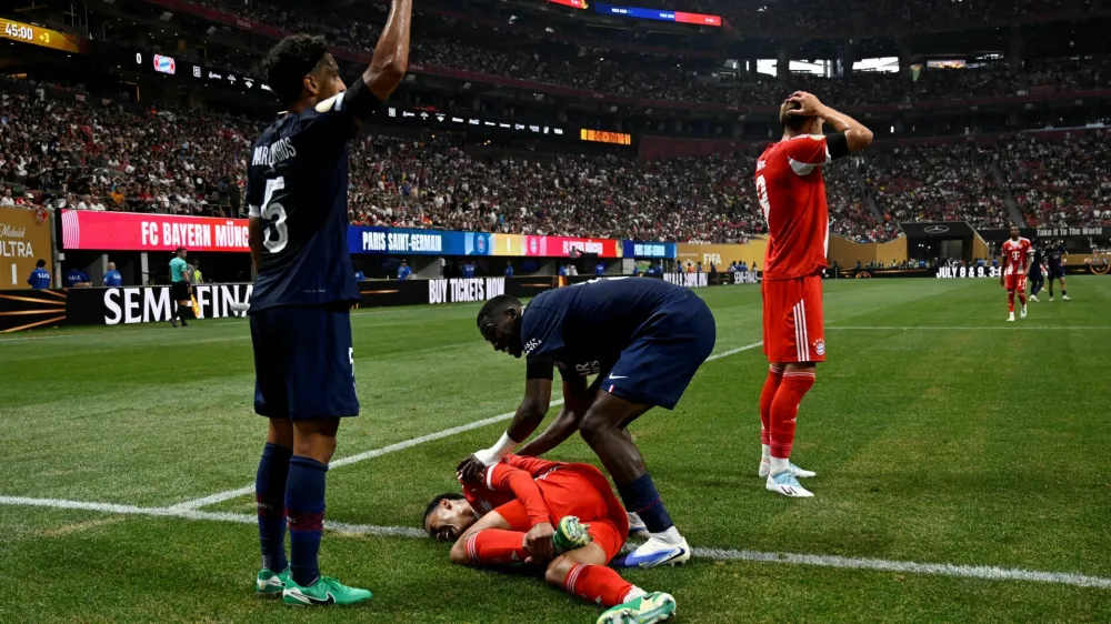FILE PHOTO: Soccer Football - FIFA Club World Cup - Quarter Final - Paris St Germain v Bayern Munich - Mercedes-Benz Stadium, Atlanta, Georgia, U.S. - July 5, 2025 Bayern Munich's Jamal Musiala sustains an injury after a collision with Paris St Germain's Gianluigi Donnarumma REUTERS/Pablo Morano/File Photo