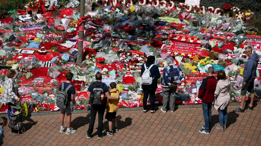 Fans pay their respects outside Anfield Stadium, following the death of Liverpool Football Club soccer player Diogo Jota, in Liverpool, Britain, July 7, 2025. REUTERS/Phil Noble