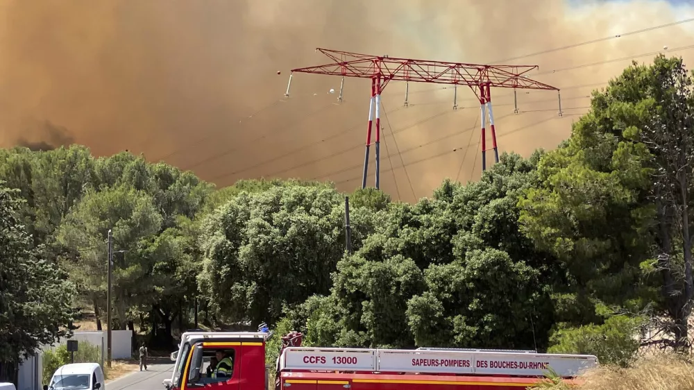 This photo provided by the fire brigade SDIS13, smoke rises during a wildfire near Marseille, southern France, Tuesday, July 8, 2025. (SDIS13 via AP)