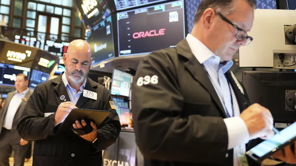 Federico DeMarco, left, and Ed Curran work on the floor at the New York Stock Exchange in New York, Wednesday, July 16, 2025. (AP Photo/Seth Wenig)