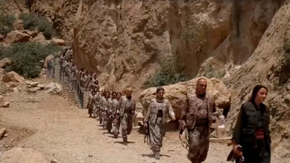 Armed PKK fighters arrive ahead of a disarming ceremony in Sulaimaniya, Iraq, July 11, 2025, in this?screengrab?obtained from a handout video. KURDISTAN WORKERS PARTY MEDIA OFFICE/Handout via REUTERS THIS IMAGE HAS BEEN SUPPLIED BY A THIRD PARTY