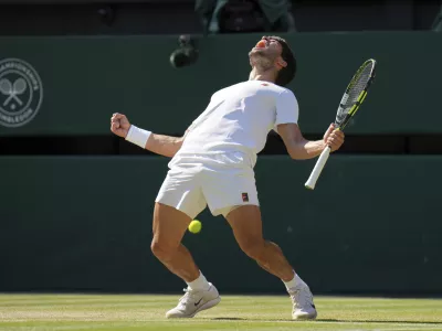 Spain's Carlos Alcaraz celebrates after beating Taylor Fritz of the U.S. in a men's singles semifinal at the Wimbledon Tennis Championships in London, Friday, July 11, 2025. (AP Photo/Kin Cheung)