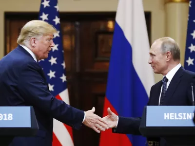 FILE - U.S. President Donald Trump shakes hands with Russian President Vladimir Putin at the end of a news conference at the Presidential Palace in Helsinki, Finland, on July 16, 2018. (AP Photo/Alexander Zemlianichenko, File)